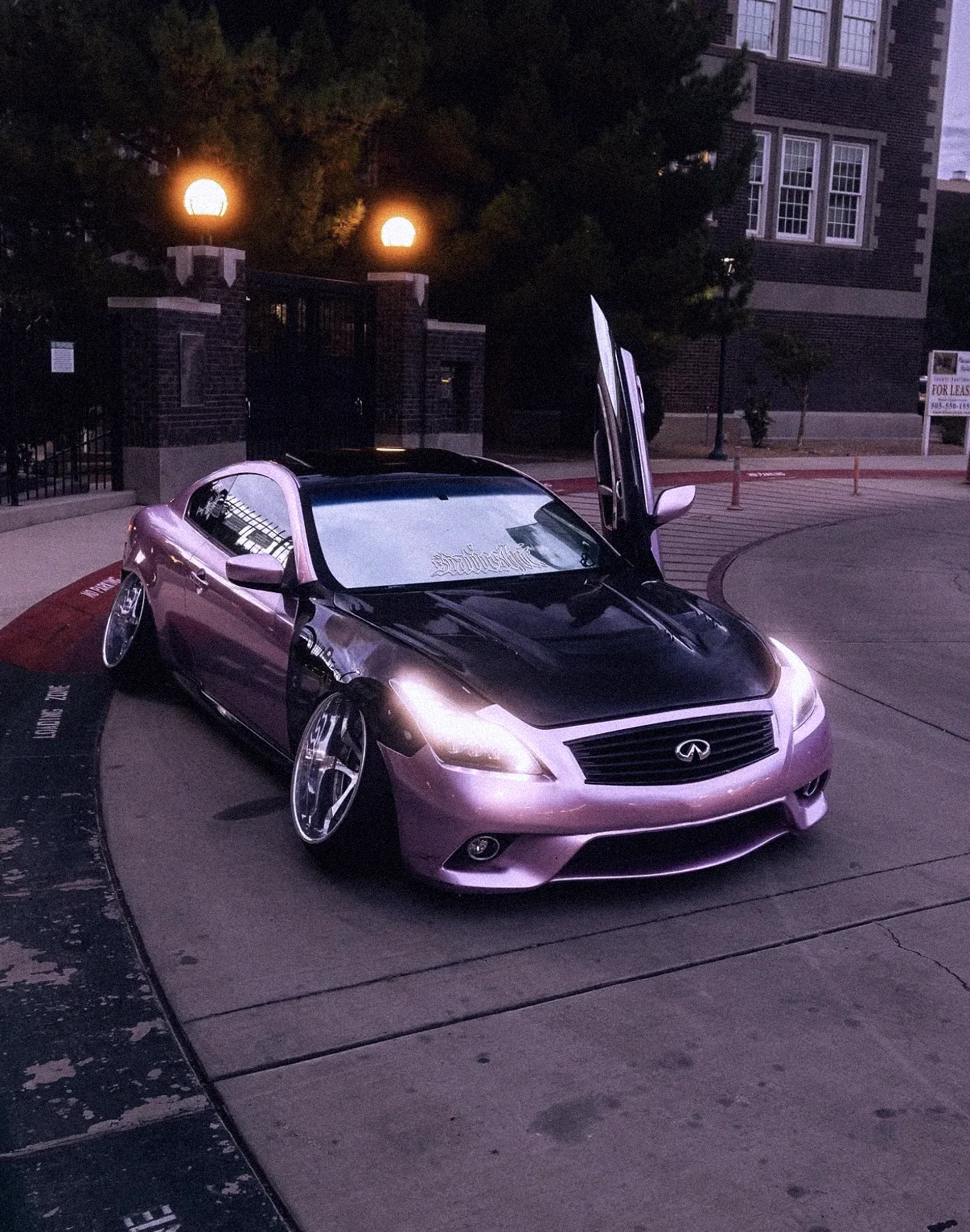 Pink Infiniti coupe with its doors up